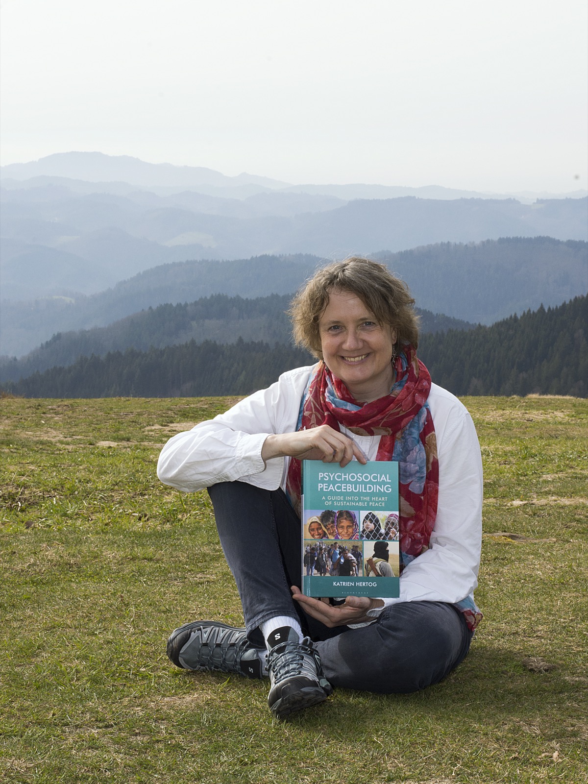 Dr. Katrien Hertog holding Psychosocial Peacebuilding outdoors